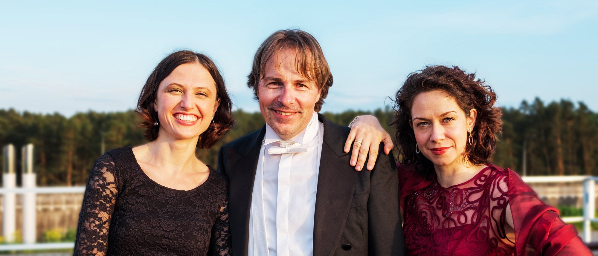 Alina Pronina, Burkhard von Puttkamer und Barbara Berg lachend im Abendlicht an Deck der Excellence Coral